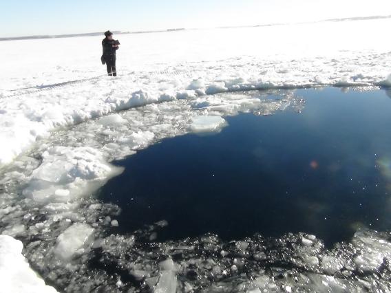 End of the line: a crater in a frozen lake. Credit:  ITAR-TASS Itar-Tass Photos/Newscom.